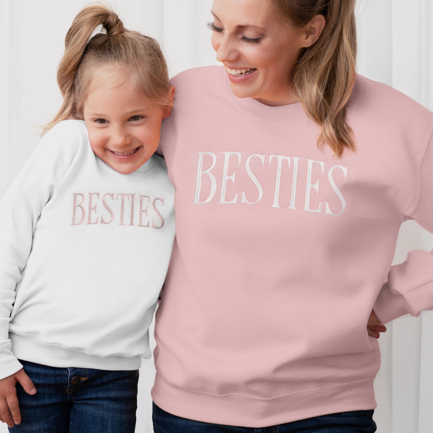 Woman and child wearing 'BESTIES' sweatshirts against a white background, besties matching mommy and me sweatshirts