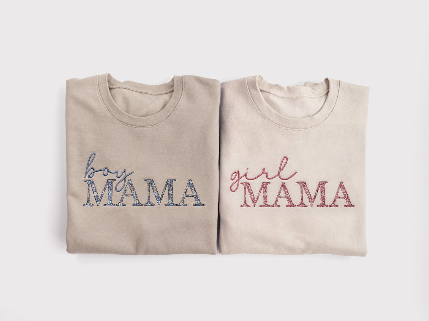 girl mama embroidered sweatshirt with pink floral embroidery gift for new mom folded next to boy mama sweatshirt