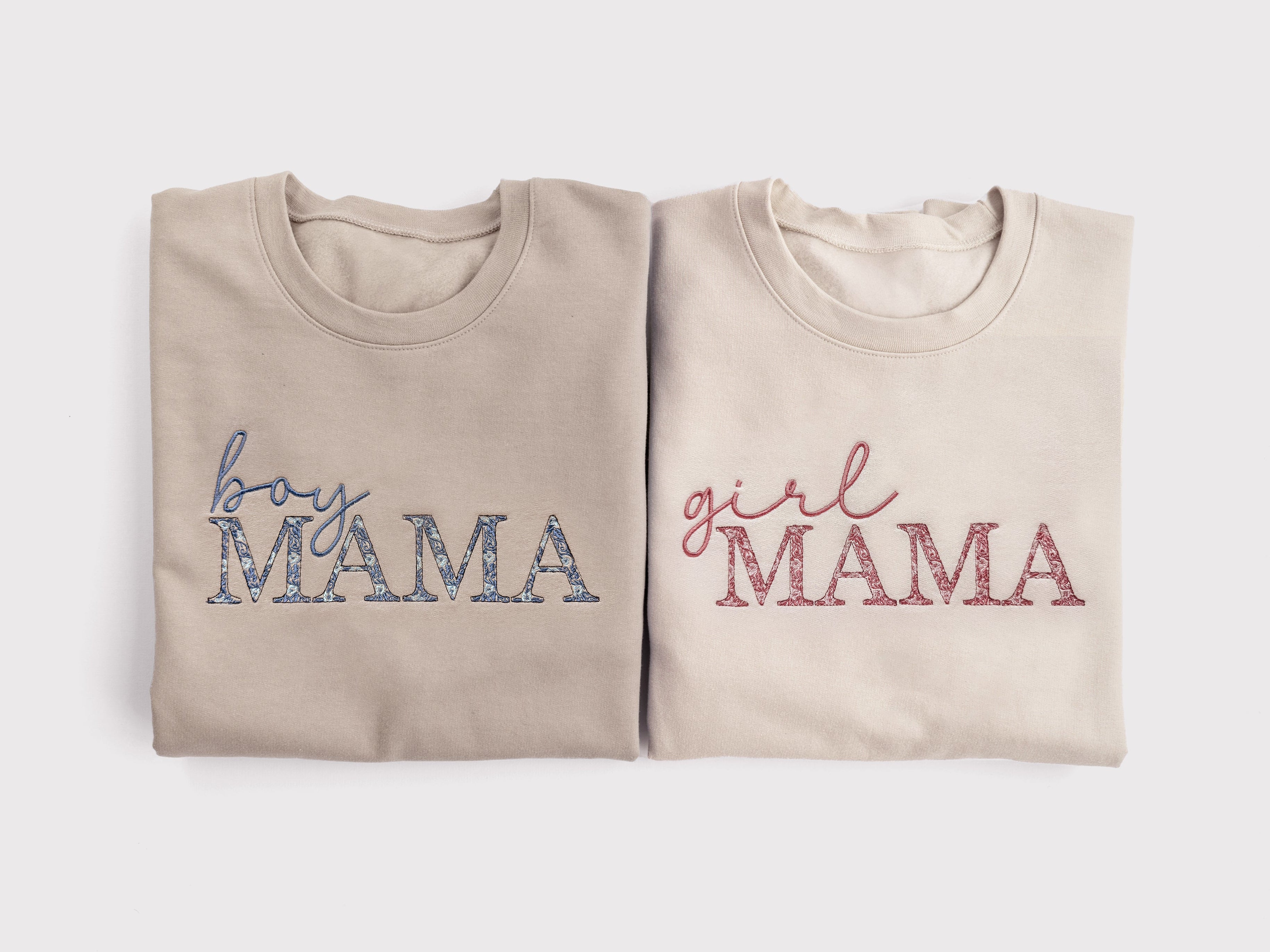 girl mama embroidered sweatshirt with pink floral embroidery gift for new mom folded next to boy mama sweatshirt