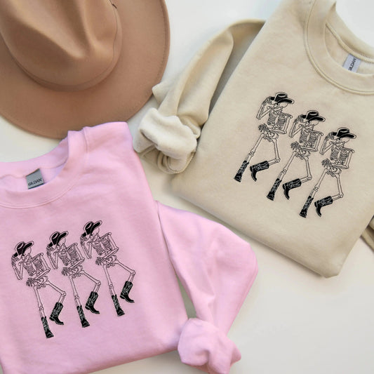 embroidered cowboy skeleton funny halloween sweatshirt halloween crewneck in pink and sand