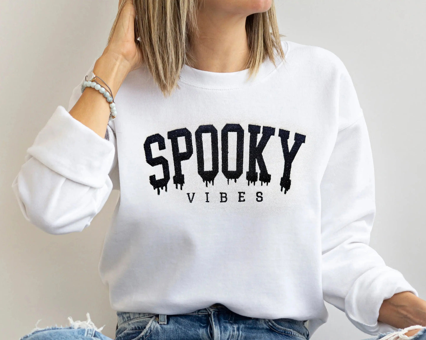 spooky vibes embroidered halloween sweatshirts for mom and baby in white on model