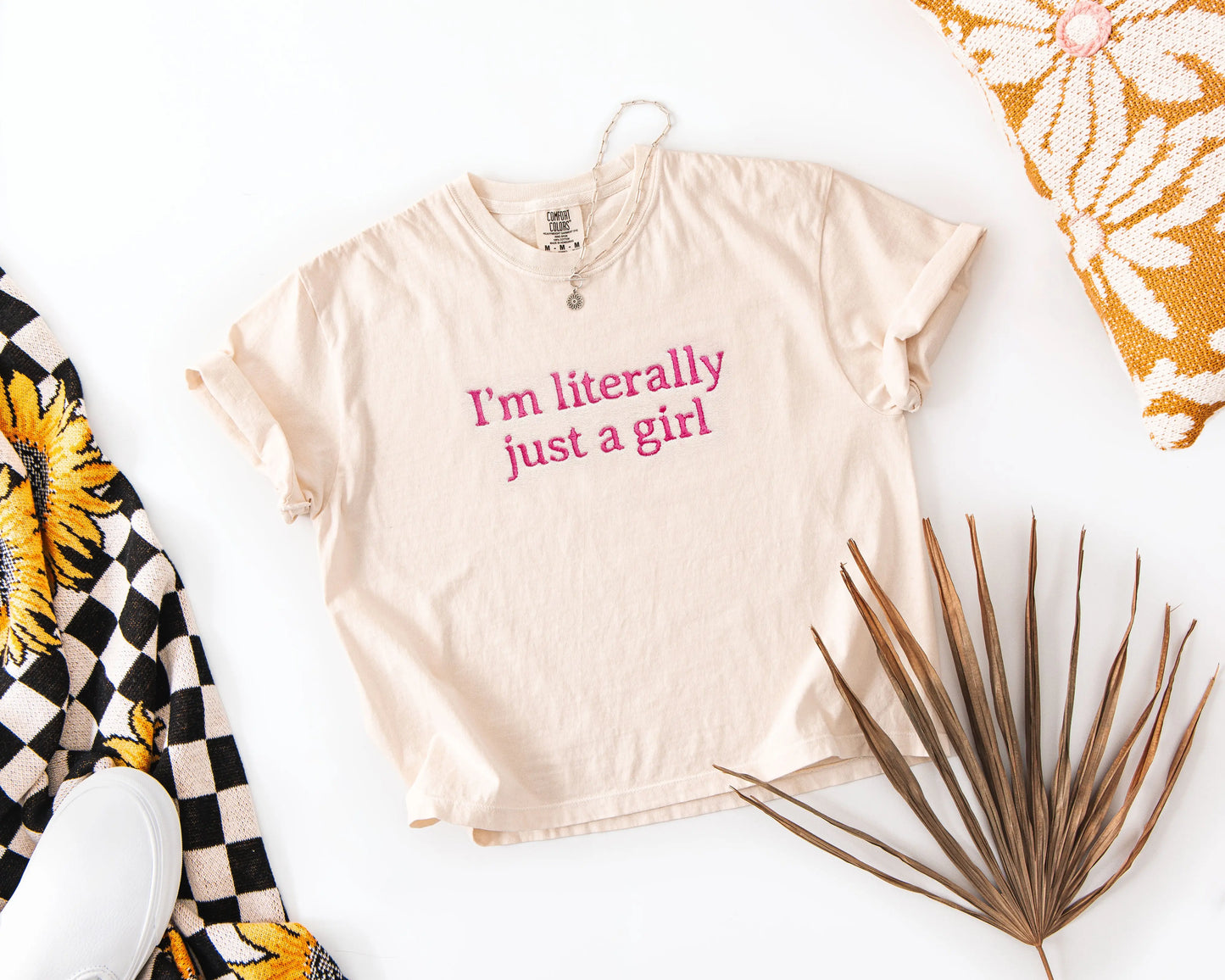 Beige t-shirt with 'I'm literally just a girl' text on a white background