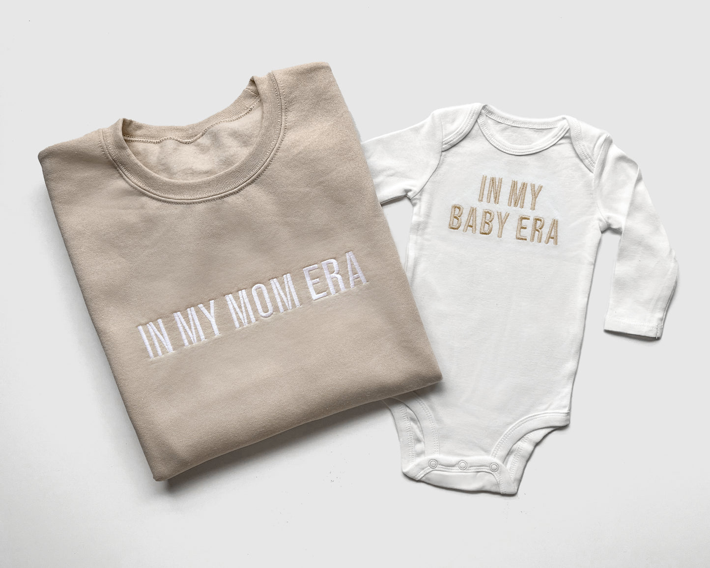 taylor swift in my mom era in my baby era matching baby onesies and sweatshirts crewneck pullover hoodie neutral beige white embroidered embroidery newborn baby shower gift new mom mommy and me mama and mini family matching outfits