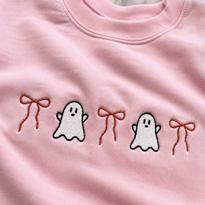 Pink embroidered ghost and bow Halloween sweatshirt on light pink fleece crewneck close up