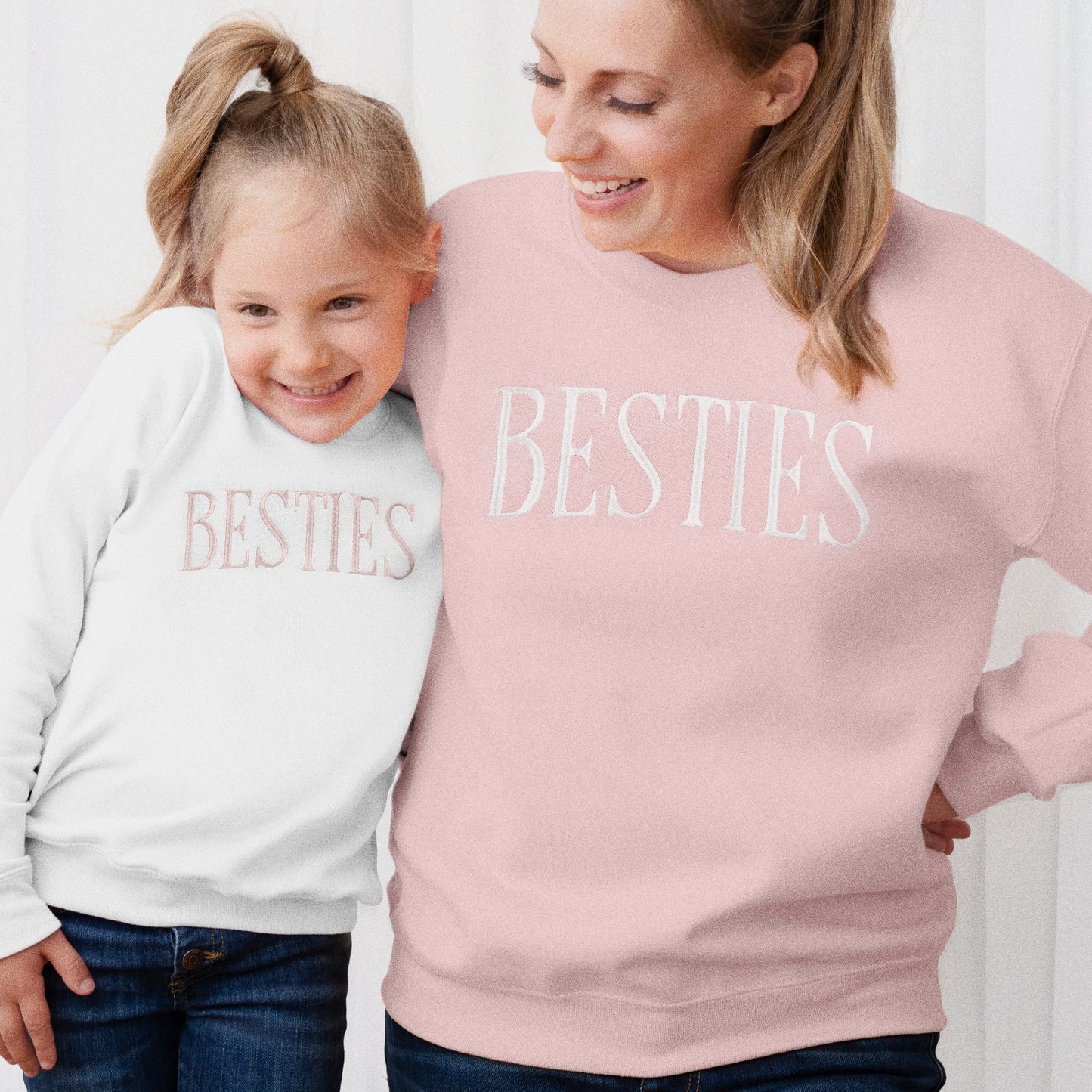Woman and child wearing 'BESTIES' sweatshirts against a white background, besties matching mommy and me sweatshirts