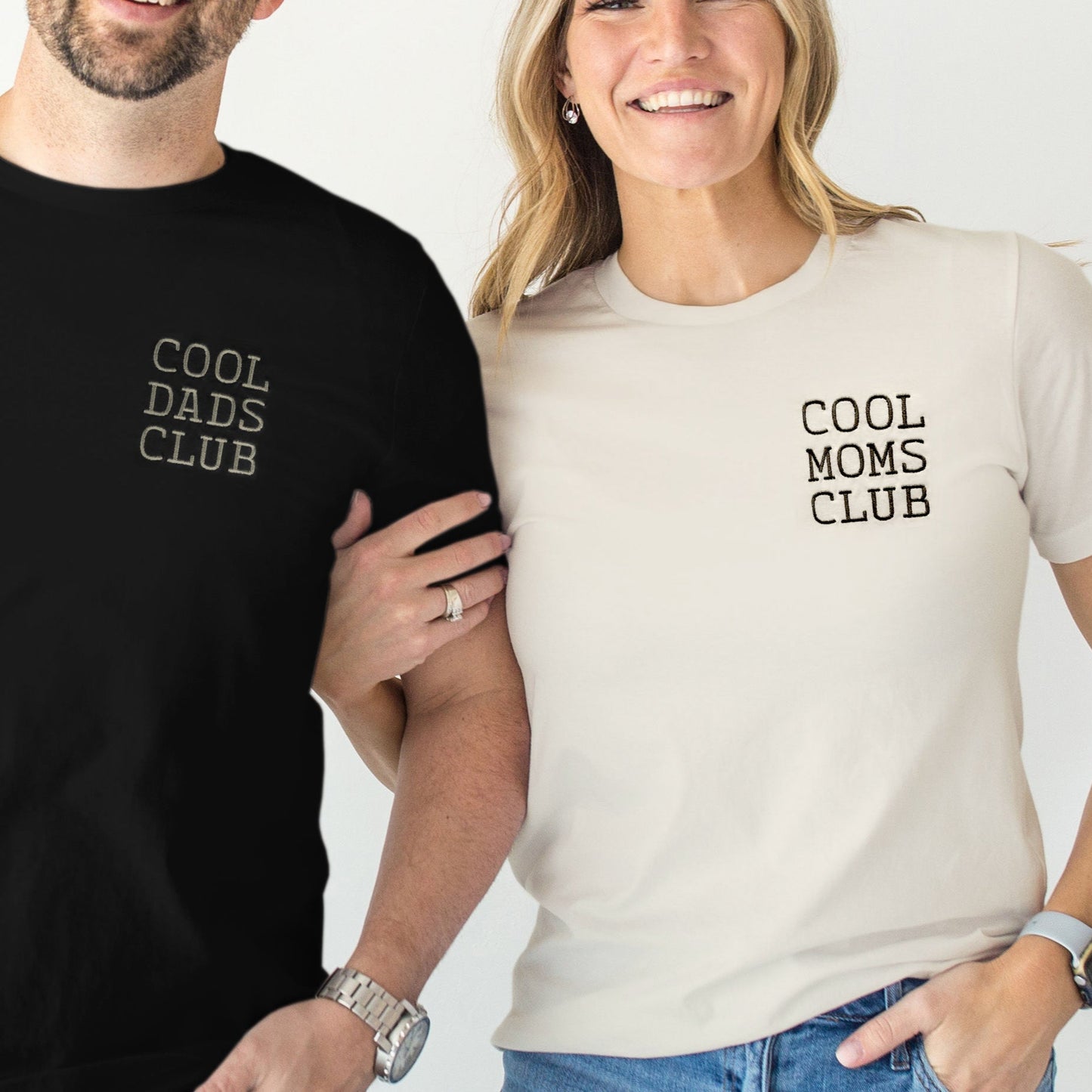 Two people wearing t-shirts with 'Cool Dads Club' and 'Cool Moms Club' text.