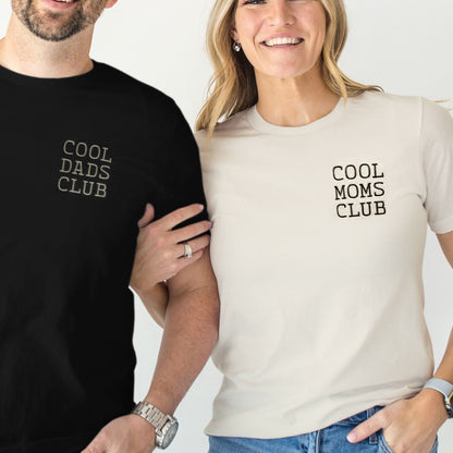 Two people wearing t-shirts with 'Cool Dads Club' and 'Cool Moms Club' text.