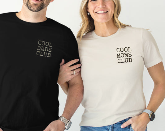 Two people wearing t-shirts with 'Cool Dads Club' and 'Cool Moms Club' text.