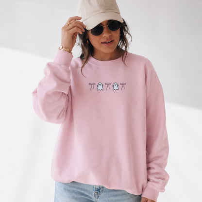 Pink embroidered ghost and bow Halloween sweatshirt on light pink fleece crewneck