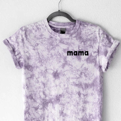 Tie-dye t-shirt with 'mama' text on a hanger against a white background
