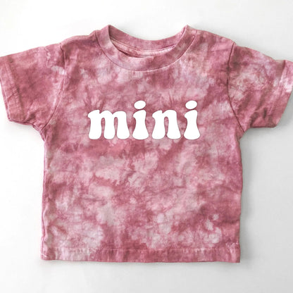 Pink tie-dye t-shirt with 'mini' text on a white background