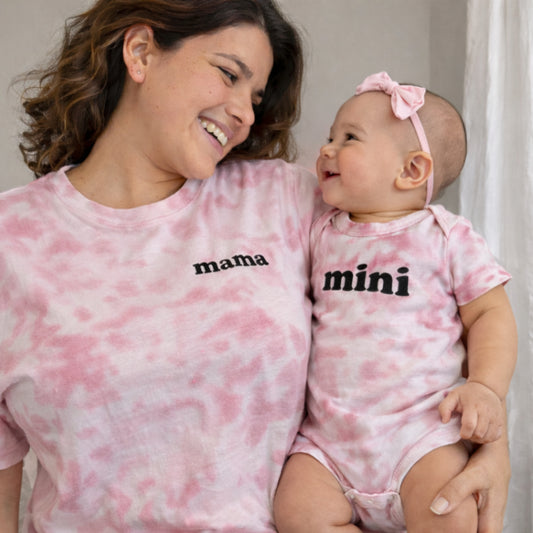 mom and baby wearing matching pink tie-dye outfits with 'mama' and 'mini' text.
