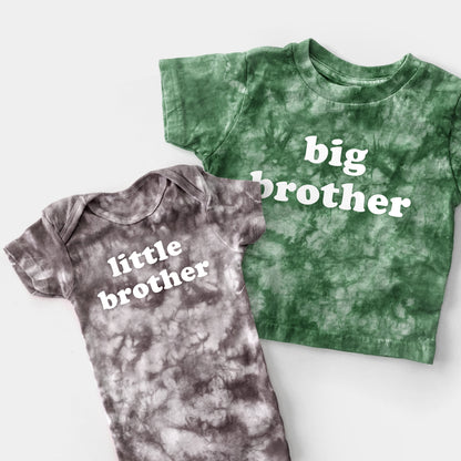 Green tie-dye shirt and gray tie-dye onesie with 'big brother' and 'little brother' text on a white background.